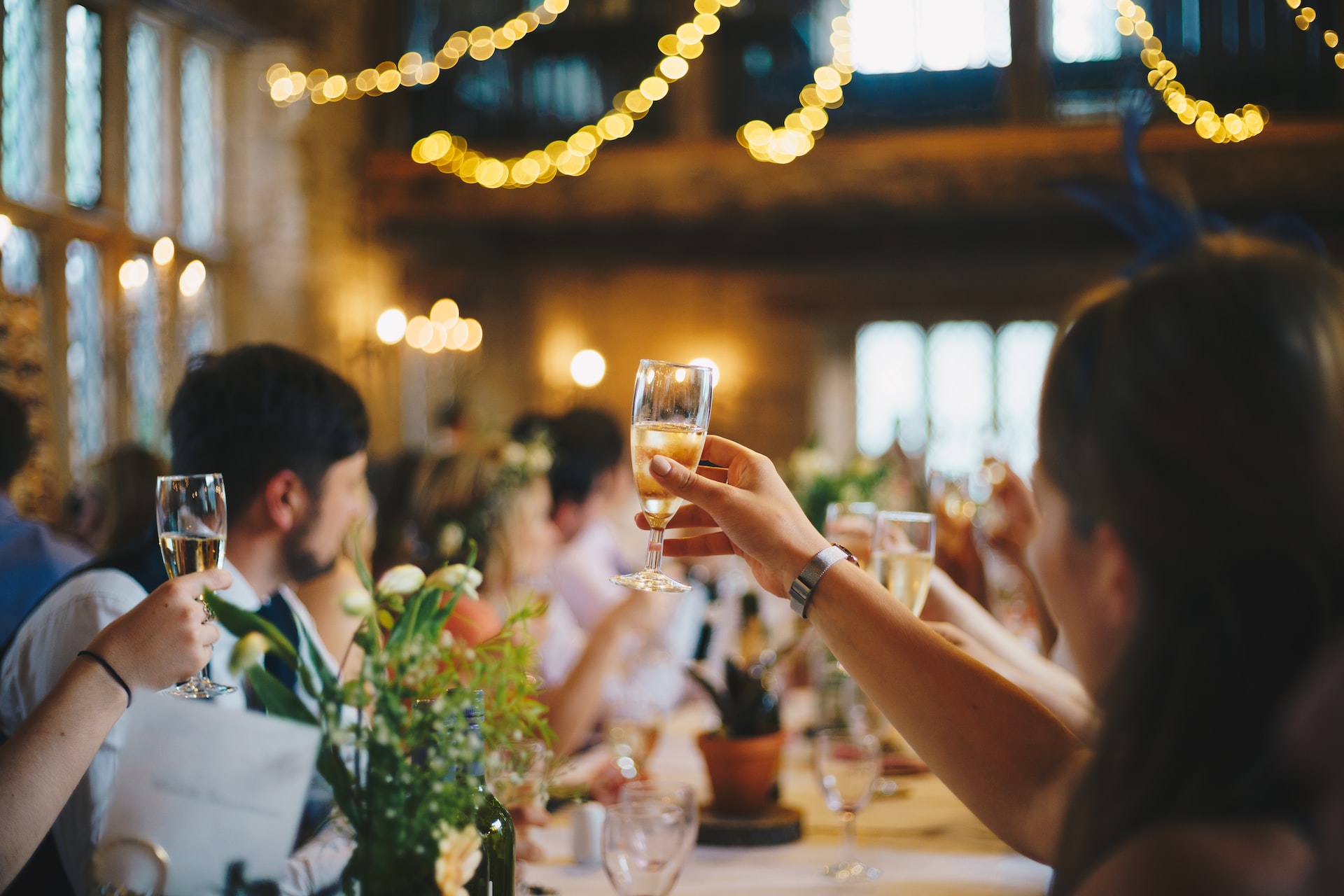 people raise glass around a table at a special event